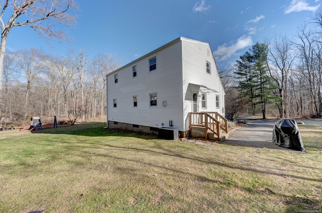 view of side of property with a yard