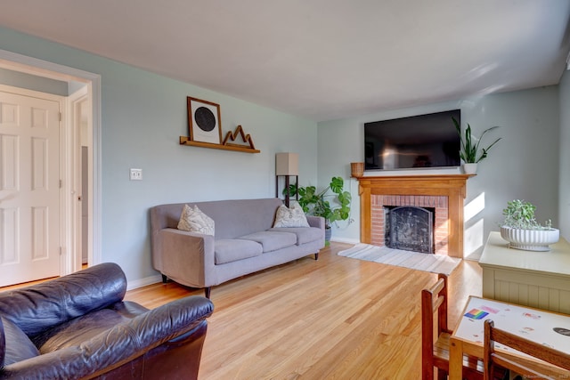 living room with a fireplace and light hardwood / wood-style floors