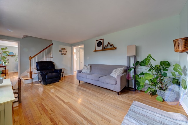 living room with a baseboard radiator and light hardwood / wood-style flooring