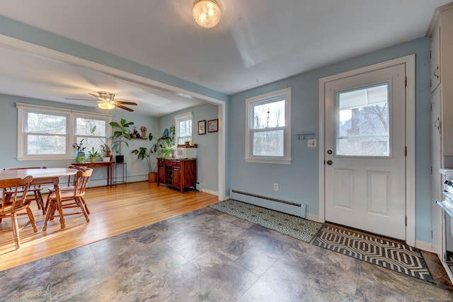 entrance foyer featuring hardwood / wood-style flooring, plenty of natural light, baseboard heating, and ceiling fan