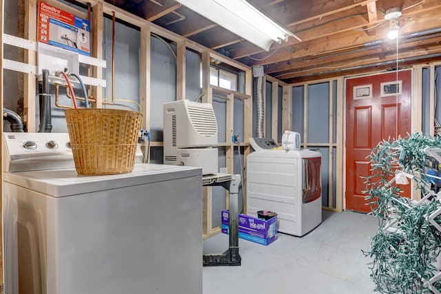 clothes washing area featuring washer and clothes dryer