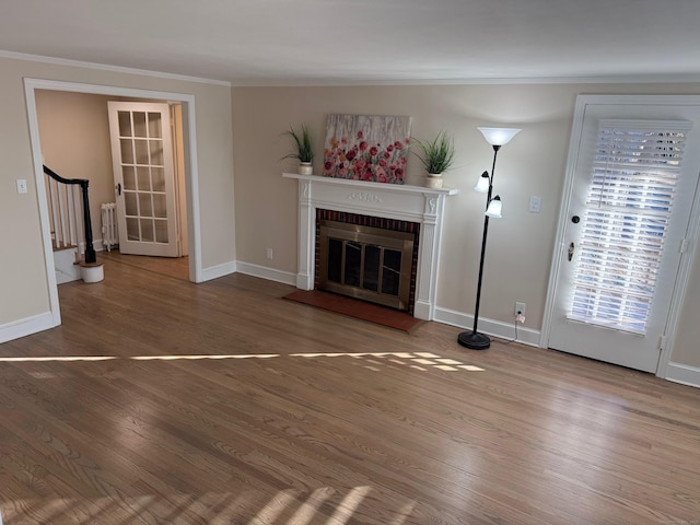 unfurnished living room featuring a fireplace, radiator heating unit, hardwood / wood-style flooring, and ornamental molding