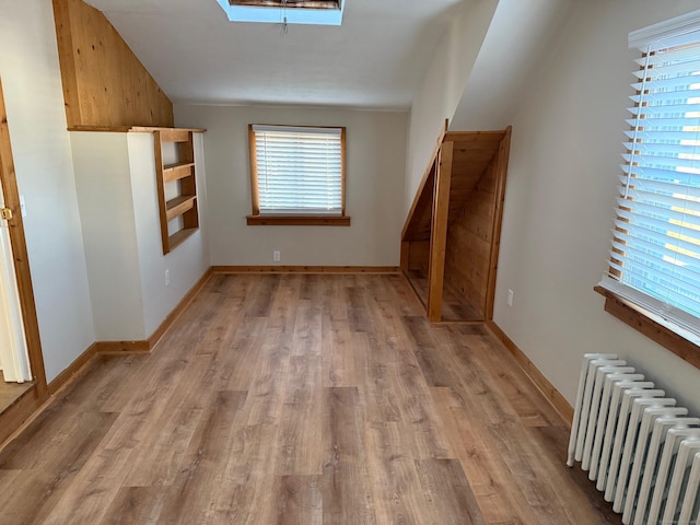 interior space featuring radiator heating unit and light wood-type flooring