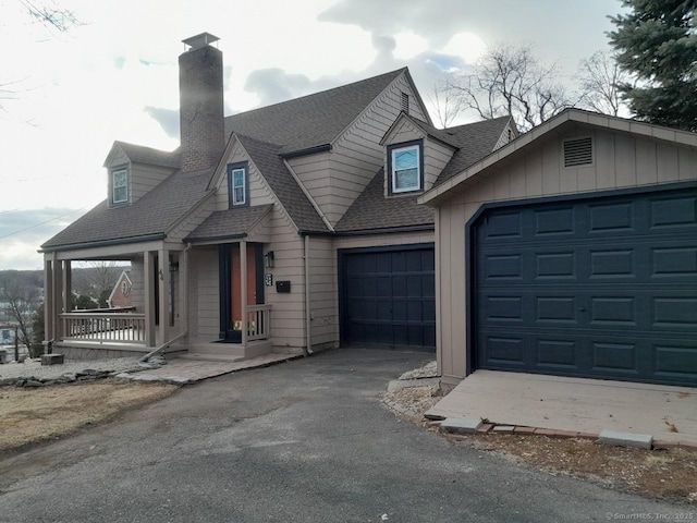 view of front of home featuring covered porch and a garage