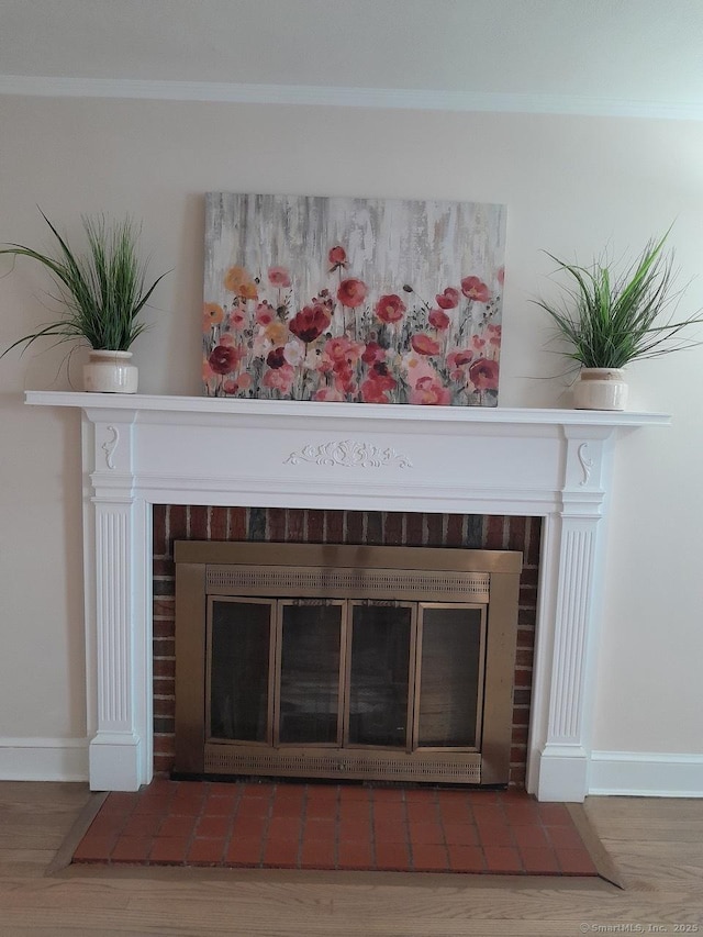 interior details with ornamental molding and hardwood / wood-style flooring