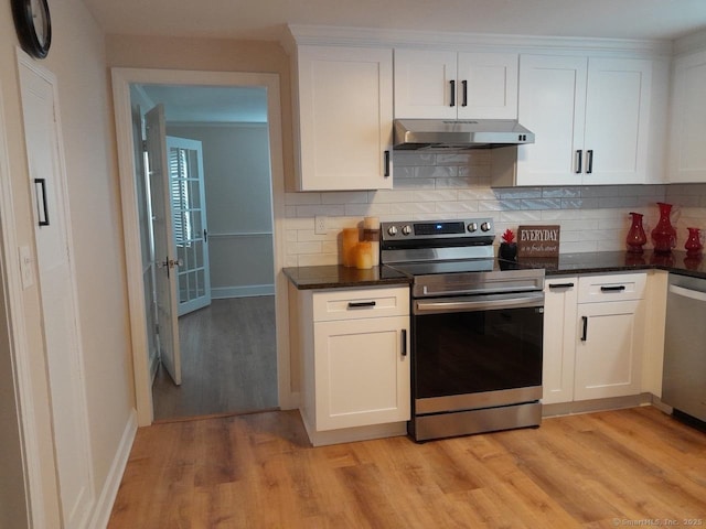 kitchen with backsplash, white cabinets, stainless steel appliances, and light wood-type flooring