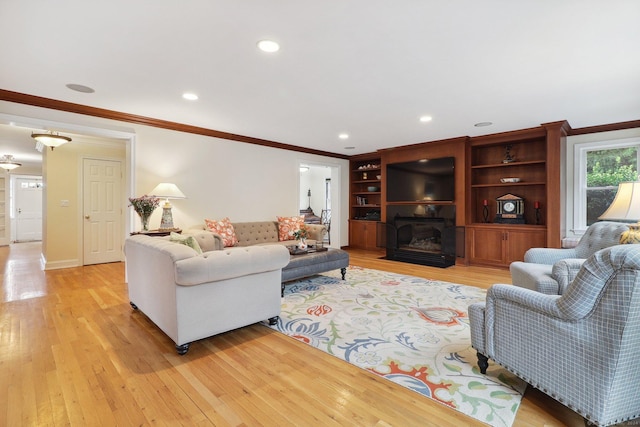 living room with light hardwood / wood-style flooring and ornamental molding