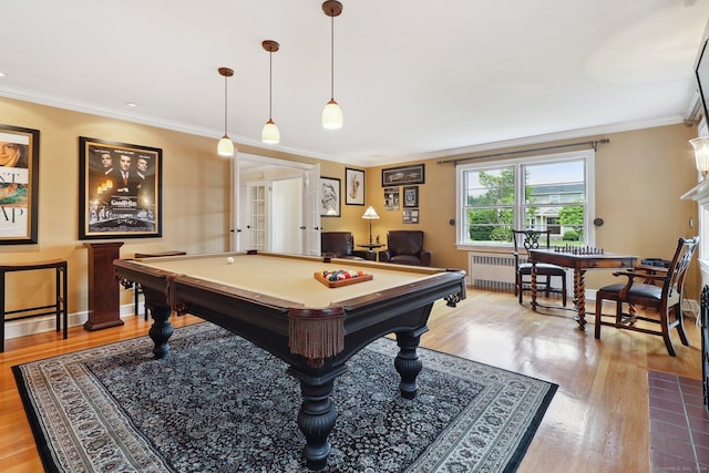 recreation room with light hardwood / wood-style floors, radiator, crown molding, and pool table