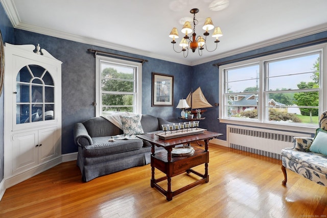 living area featuring radiator heating unit, light wood-type flooring, an inviting chandelier, and plenty of natural light