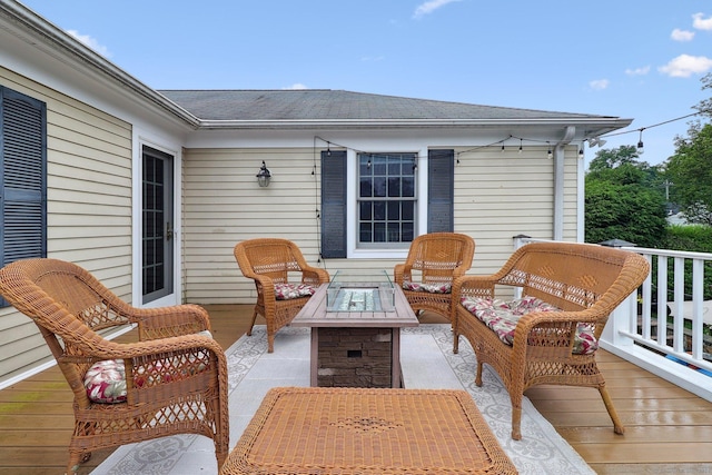 wooden deck featuring a fire pit