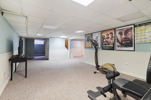 workout area with a drop ceiling and carpet floors