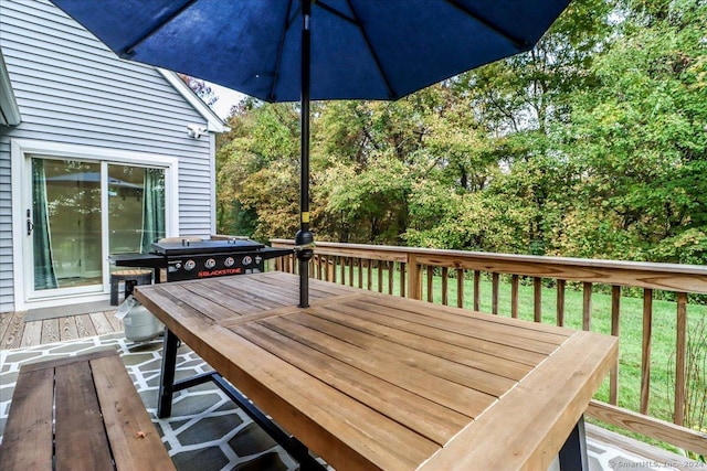 wooden deck featuring a grill