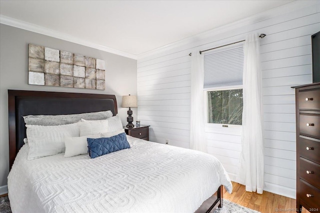 bedroom with hardwood / wood-style flooring and crown molding