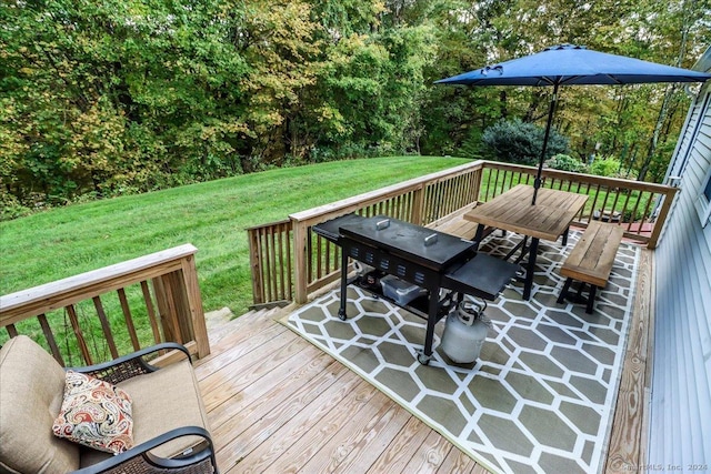 wooden terrace featuring a yard