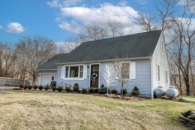 view of front facade with a front yard and a garage