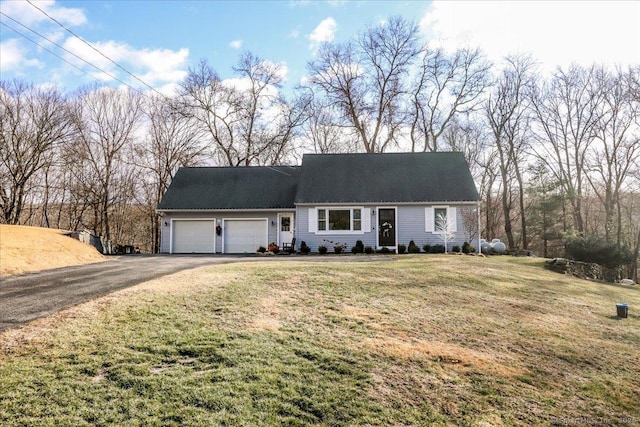 view of front of house with a front lawn and a garage