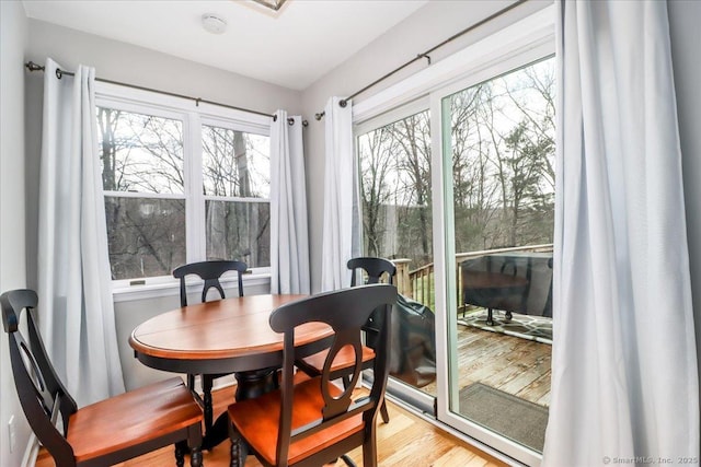 dining space with plenty of natural light and light hardwood / wood-style floors