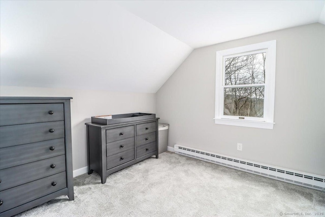 additional living space featuring light carpet, a baseboard radiator, and vaulted ceiling