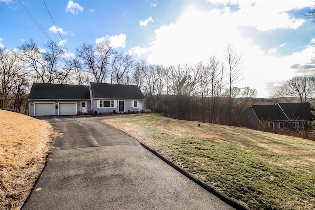 view of front of house featuring a garage and a front lawn