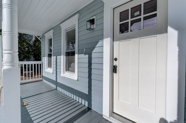 view of exterior entry featuring a porch