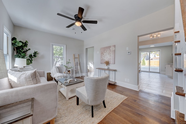 living room with hardwood / wood-style flooring and ceiling fan