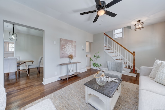 living room with ceiling fan and dark wood-type flooring