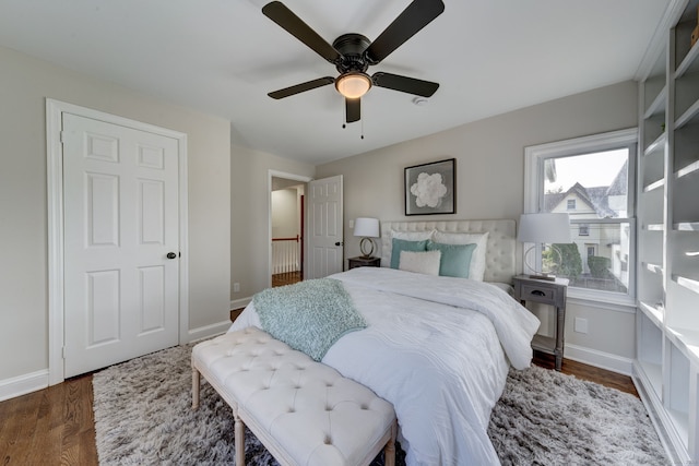 bedroom with ceiling fan, dark hardwood / wood-style floors, and multiple windows