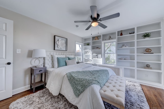 bedroom featuring radiator, ceiling fan, and dark hardwood / wood-style floors