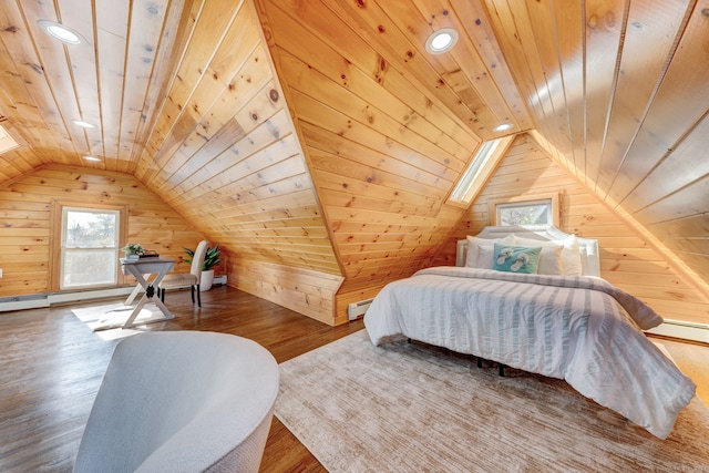 bedroom with wooden walls, wooden ceiling, a baseboard heating unit, and wood-type flooring