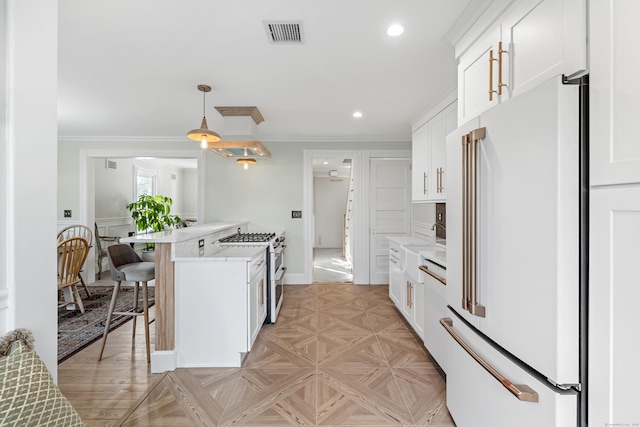 kitchen with white cabinetry, high end white refrigerator, double oven range, and a kitchen bar