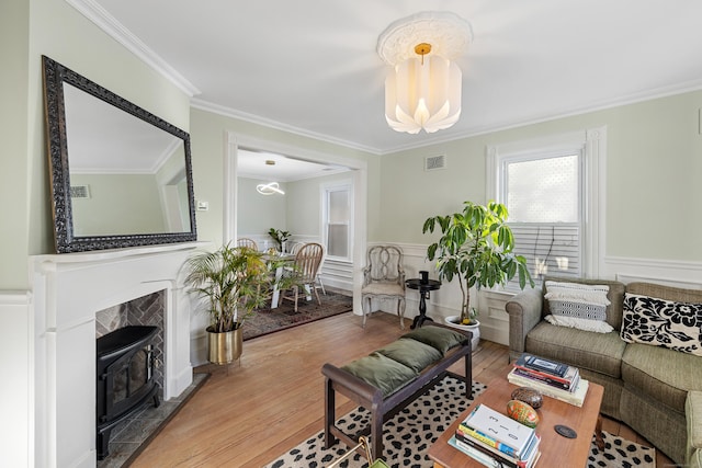 living room featuring hardwood / wood-style floors, ornamental molding, and a chandelier