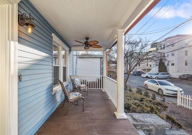 deck with ceiling fan and covered porch