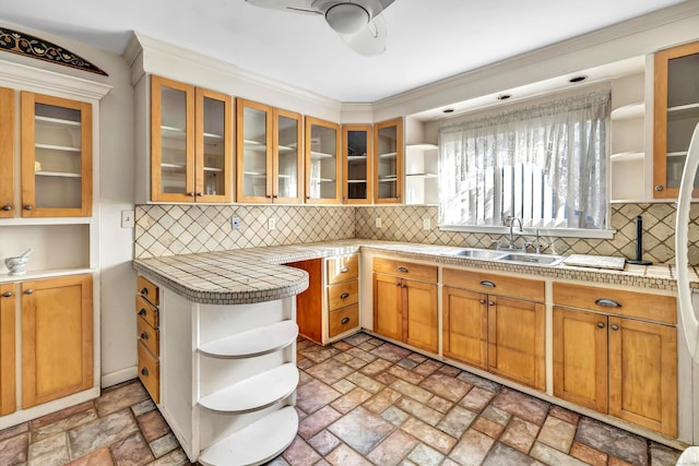 kitchen featuring sink, ceiling fan, tile countertops, and tasteful backsplash