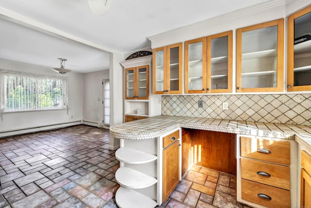 kitchen featuring tile countertops, tasteful backsplash, and kitchen peninsula