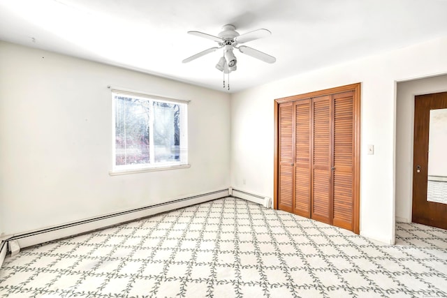 unfurnished bedroom featuring baseboard heating, ceiling fan, and a closet