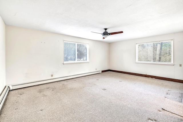 empty room featuring ceiling fan and a baseboard heating unit