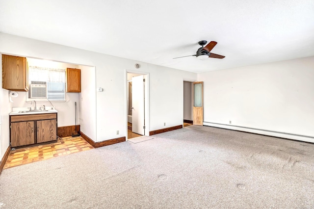 unfurnished living room with sink, ceiling fan, light carpet, and a baseboard radiator