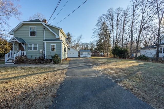 view of side of property with a lawn and a garage