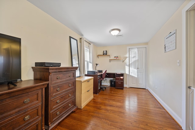 home office with dark hardwood / wood-style floors