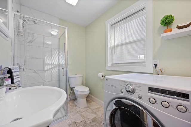 bathroom with toilet, an enclosed shower, washer / clothes dryer, and sink