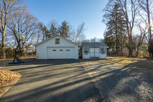 exterior space with a garage and an outbuilding