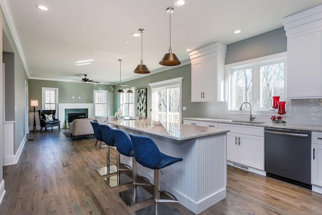 LOT7 Deerwood Rd, Oxford, CT 06478 - kitchen featuring dishwashing machine, a sink, light stone countertops, a kitchen bar, and white cabinetry