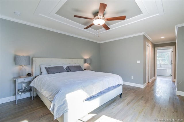 bedroom with a raised ceiling, ceiling fan, hardwood / wood-style flooring, and ornamental molding