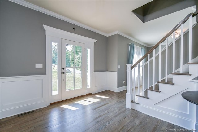 entrance foyer with plenty of natural light, ornamental molding, and hardwood / wood-style flooring