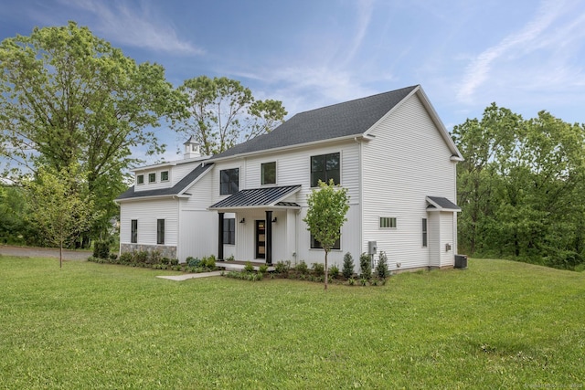 modern farmhouse featuring a front yard and central AC unit