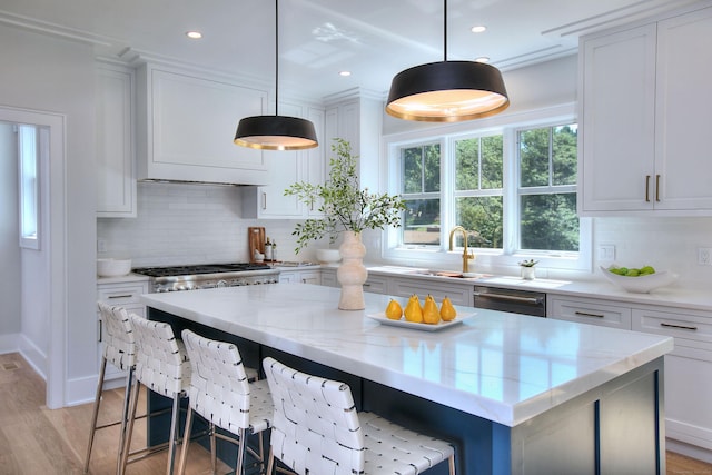 kitchen with a kitchen island, white cabinetry, hanging light fixtures, and tasteful backsplash