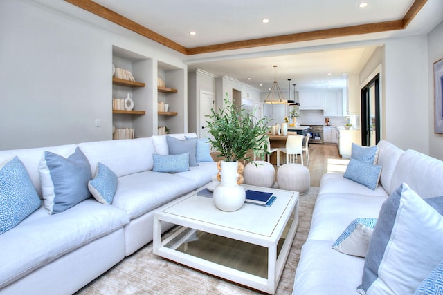 living room with light wood-type flooring and built in features