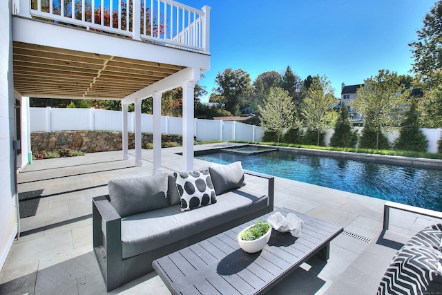 view of pool featuring an outdoor living space, a patio, and an in ground hot tub