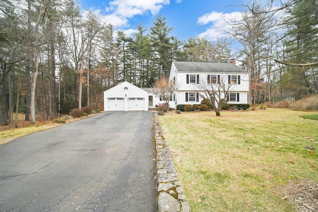 view of front of house with a garage and a front lawn