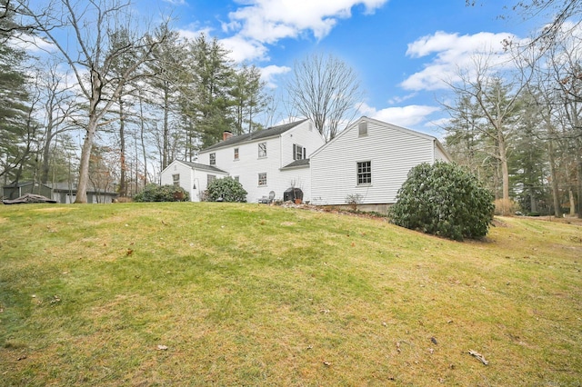 rear view of house with a yard